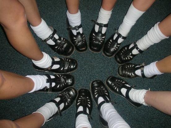 Circle of schoolgirls wearing t-bars and white socks